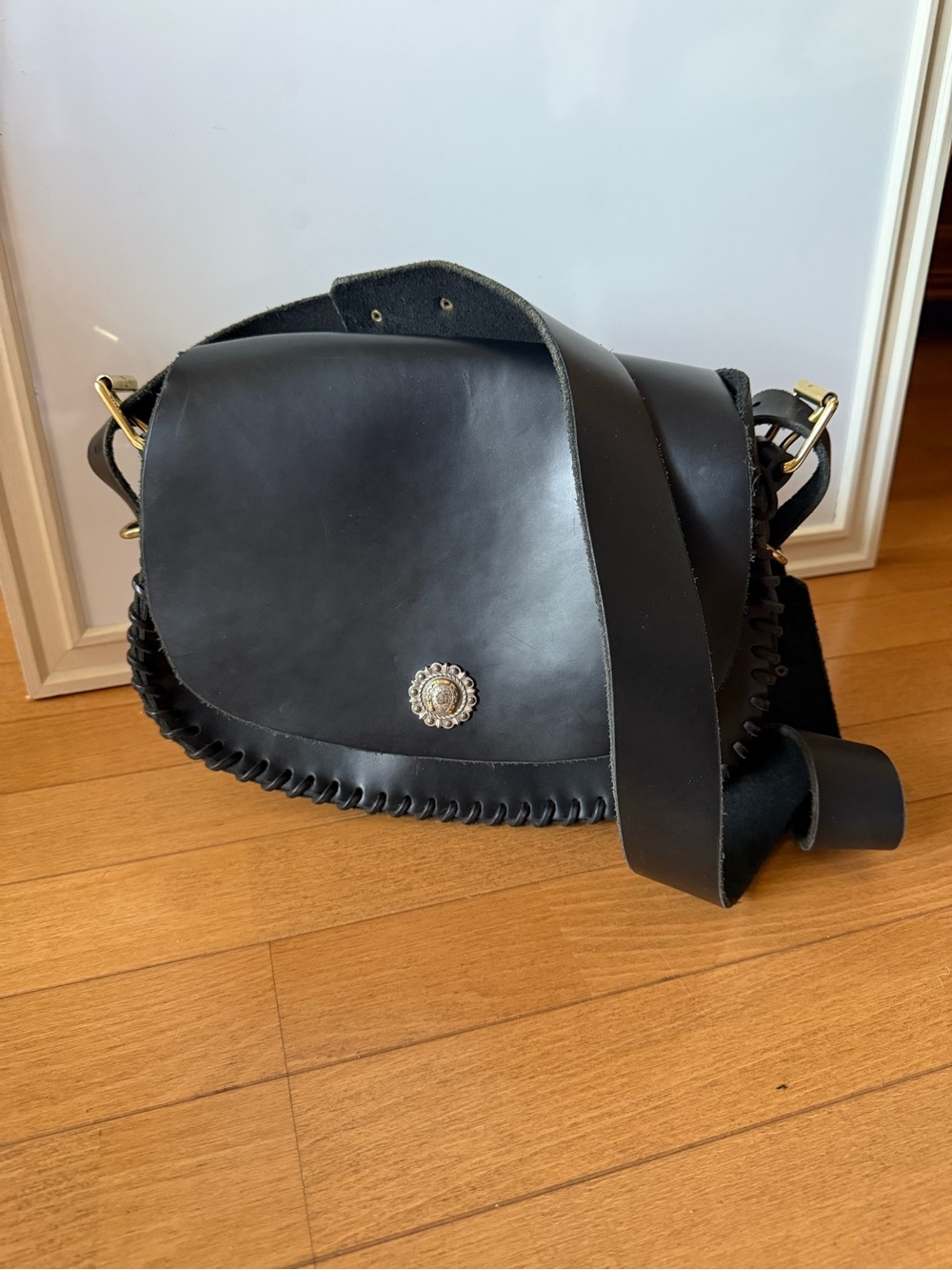 Black Leather Saddle Bag with Decorative Medallion